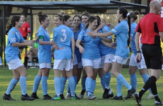Picture of Perth Soccer club players after a goal has been scored.players