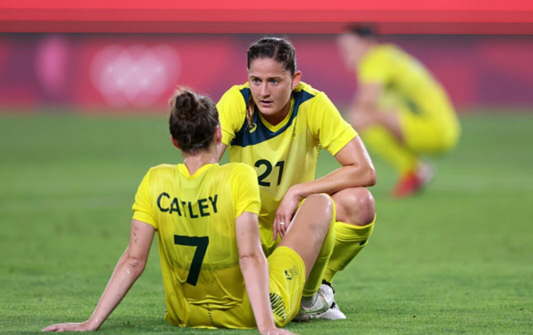 KASHIMA, JAPAN - AUGUST 05: Steph Catley #7 of Team Australia is consoled by Laura Brock #21 following defeat in the Women's Bronze Medal match between United States and Australia on day thirteen of the Tokyo 2020 Olympic Games at Kashima Stadium on August 05, 2021 in Kashima, Japan. (Photo by Elsa/Getty Images)