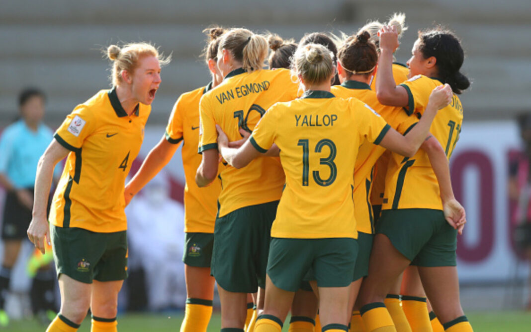 MUMBAI, INDIA - JANUARY 24: Australia players celebrate their first goal scored by Sam Kerr (obscured) during the AFC Women's Asian Cup Group B match between Philippines and Australia at Mumbai Football Arena on January 24, 2022 in Mumbai, India. (Photo by Thananuwat Srirasant/Getty Images)