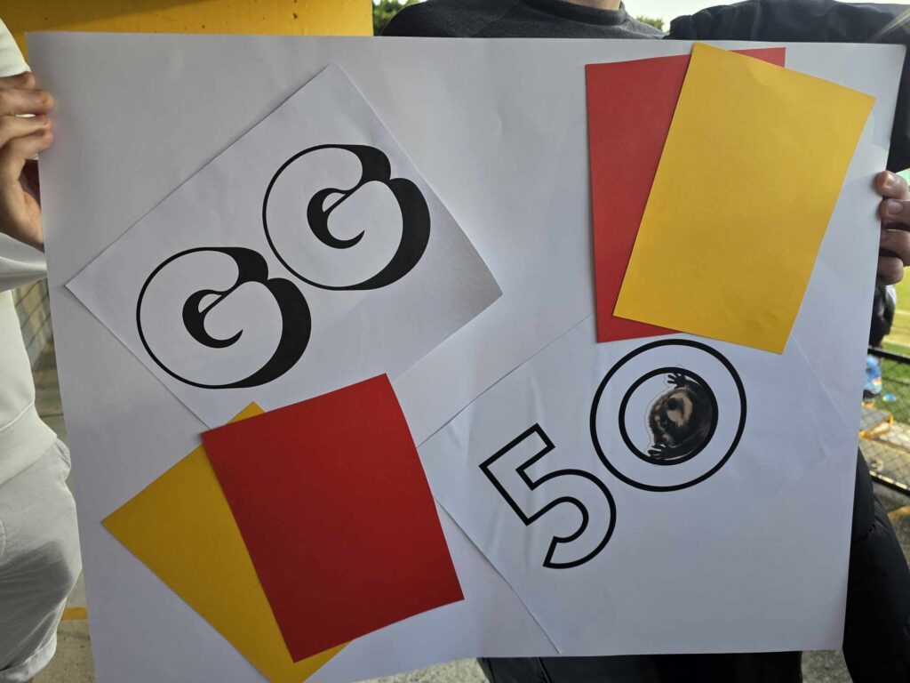 A sign made to commemorate Georgia Ghirardello's 50th game as an A-League Women referee. Image and sign supplied by Delfina Shakespear.