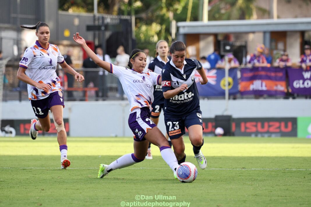 Melbourne Victory forward Rachel Lowe (Matildas Cap #201) tries to evade a tackle from Philippines international / Perth Glory midfielder Quinley Quezada, during a 2023-24 A-League Women match between Glory and Victory. Photo credit: Dan Ullman (Instagram - @aptitudephotography)