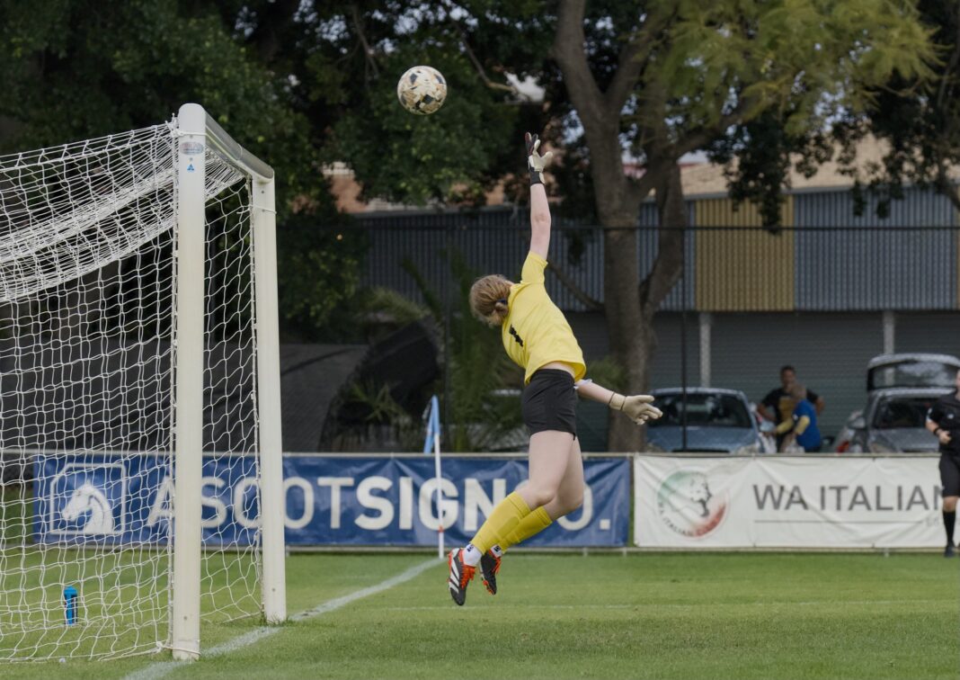 Fremantle Goalkeeper, Dayle Schroeder, tries in vain to stop Perth SC's third goal in the Perth SC vs Fremantle Rd 15 NPLW WA game. Image Credit Robert Lizzi Photography