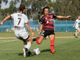 Indiah-Paige Riley goes in for a challenge, while playing for Brisbane Roar against Western Sydney Wanderers, during the 2018-19 A-League Women season. Photo credit: Kellie Lemon / KLZ Photography