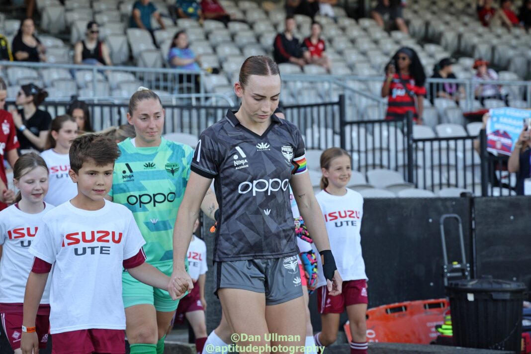 Wellington Phoenix defender Mackenzie Barry leads her team out ahead of their 2024-25 Unite Round game against Adelaide United at Netstrata Jubilee Stadium. Photo credit: Dan Ullman (Instagram - @aptitudephotgraphy )