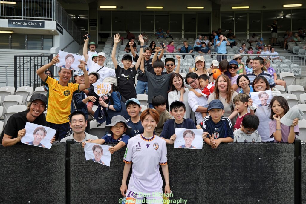 Perth Glory midfielder Miku Sunaga poses with the Miku Sunaga Fan Club at 2024-25 Unite Round. Photo credit: Dan Ullman (Instagram - @aptitudephotography )