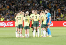 PODCAST | Green Card The Matildas huddle before the second half ot their game against New Zealand, at Gosford on 28 November 2025. Photo credit: Kellie Stewart / KLZ Photography (Instagram - @klzphotography )